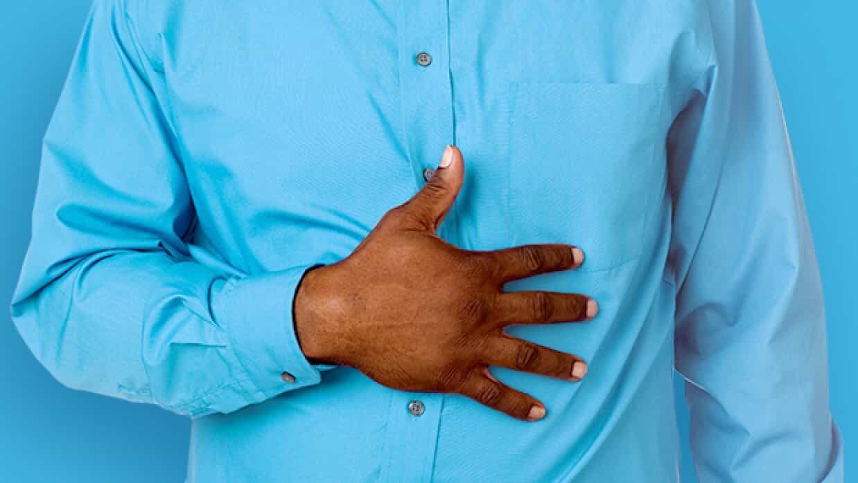 Man with heartburn clutching abdomen