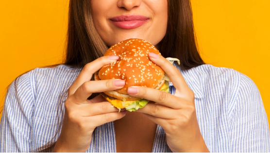 Woman eating a cheeseburger